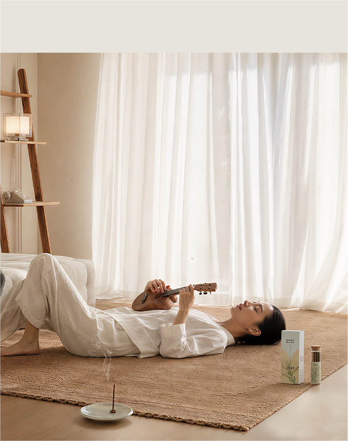 Woman resting with a small instrument in a sunlit room
